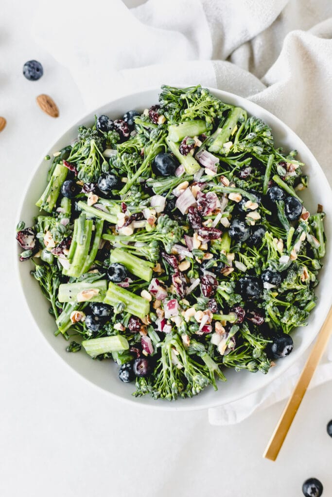 overhead view of broccolini superfood salad in a white bowl.