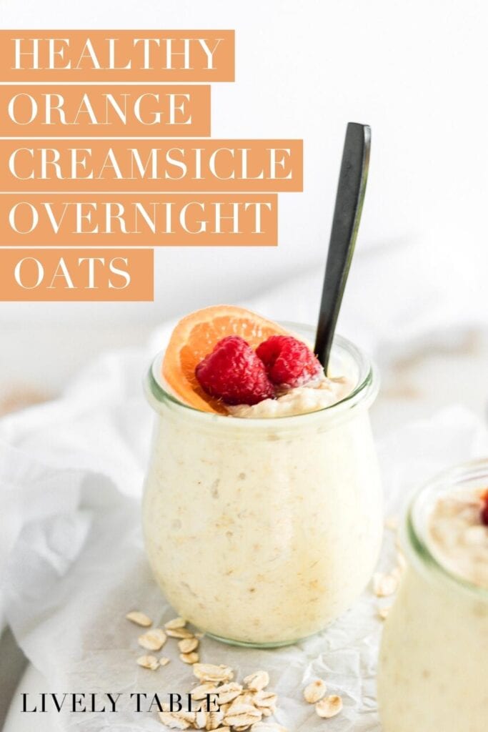 jar of orange creamsicle overnight oats topped with an orange slice and raspberries with text overlay.
