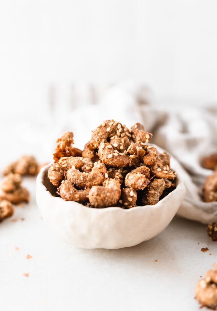 maple tahini cashew clusters in a small white bowl.