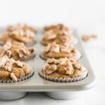 close up of gluten free maple walnut pumpkin blender muffins in a muffin tin