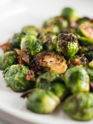 closeup of Bourbon Brown Sugar Roasted Brussels Sprouts with Bacon on a plate.