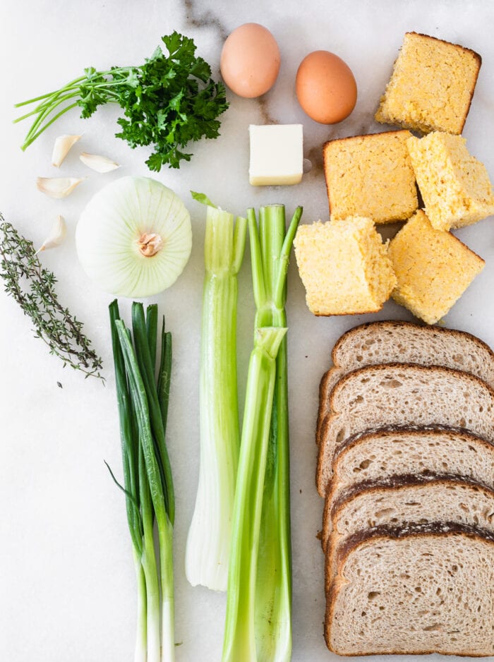 overhead view of ingredients needed to make southern cornbread stuffing on a white background.