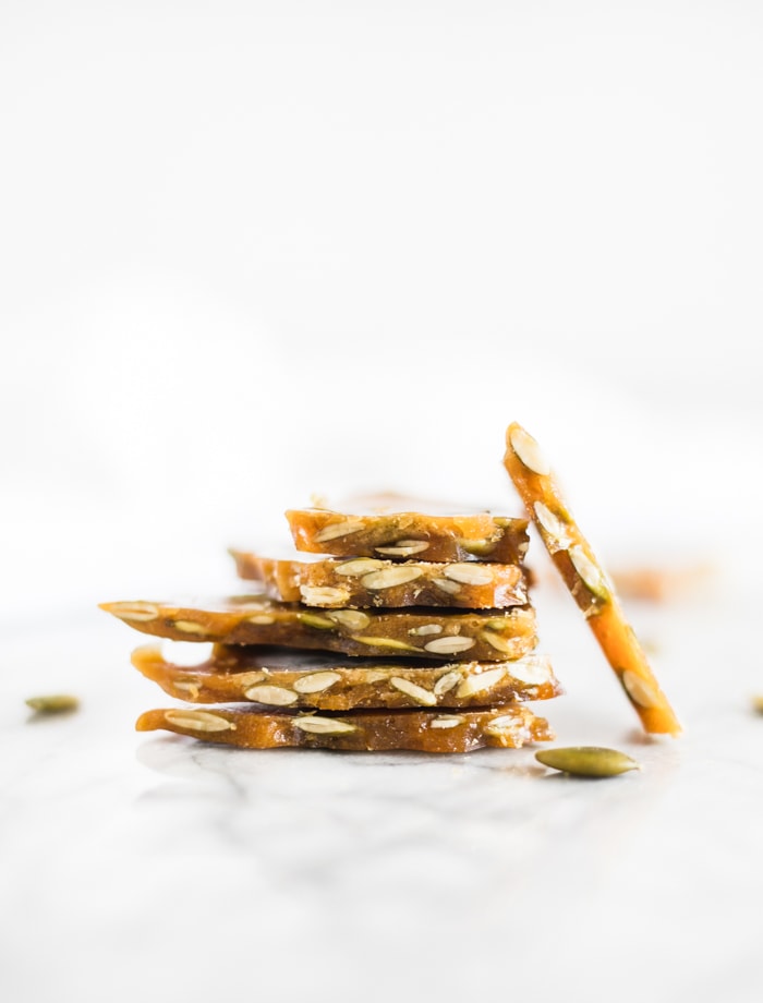 pieces of stacked maple bourbon pumpkin seed brittle.