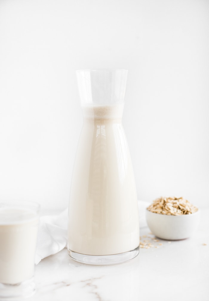 oat milk in a glass carafe.