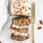 overhead view of sliced hummingbird banana bread with a gold knife next to it.