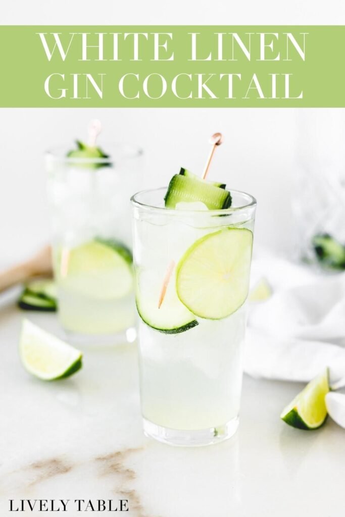 white linen cocktail in a glass garnished with lime and cucumber slices with text overlay.