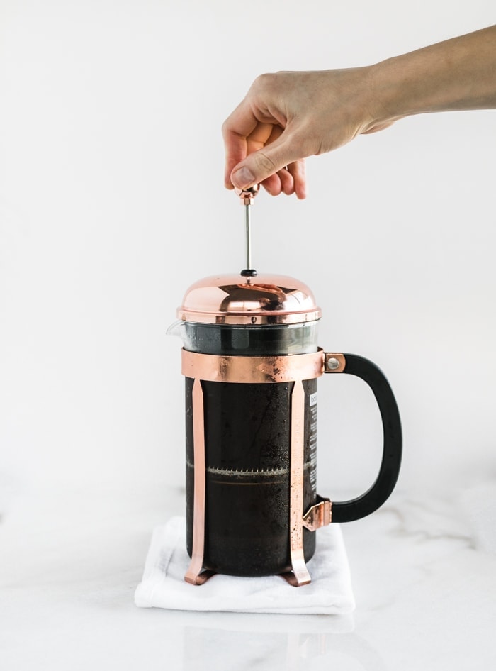 cold brew coffee in french press being pressed