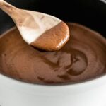 closeup of mole negro on a wooden spoon.