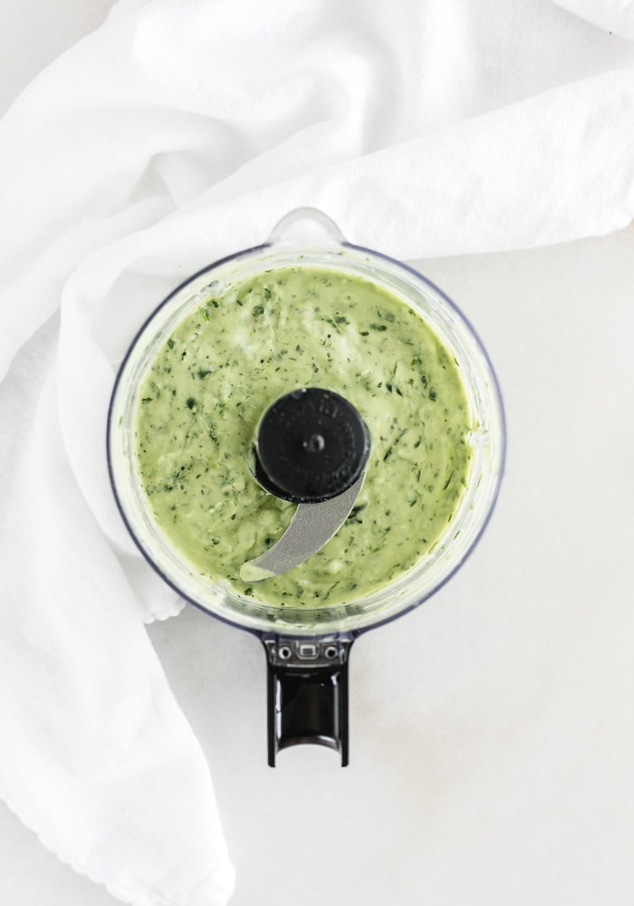 overhead view of green goddess dressing in a food processor.