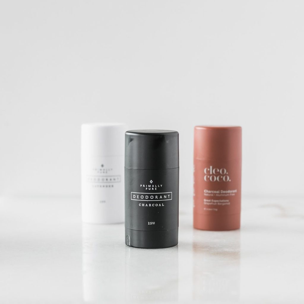 three natural deodorants against a white background.