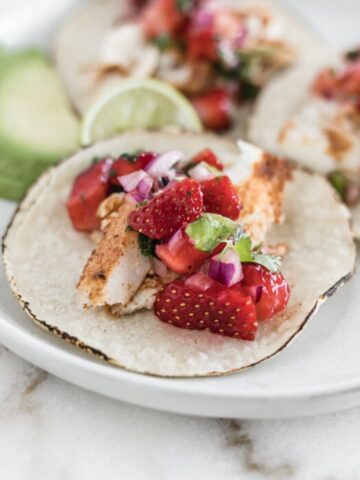 closeup of grilled fish taco with strawberry salsa.