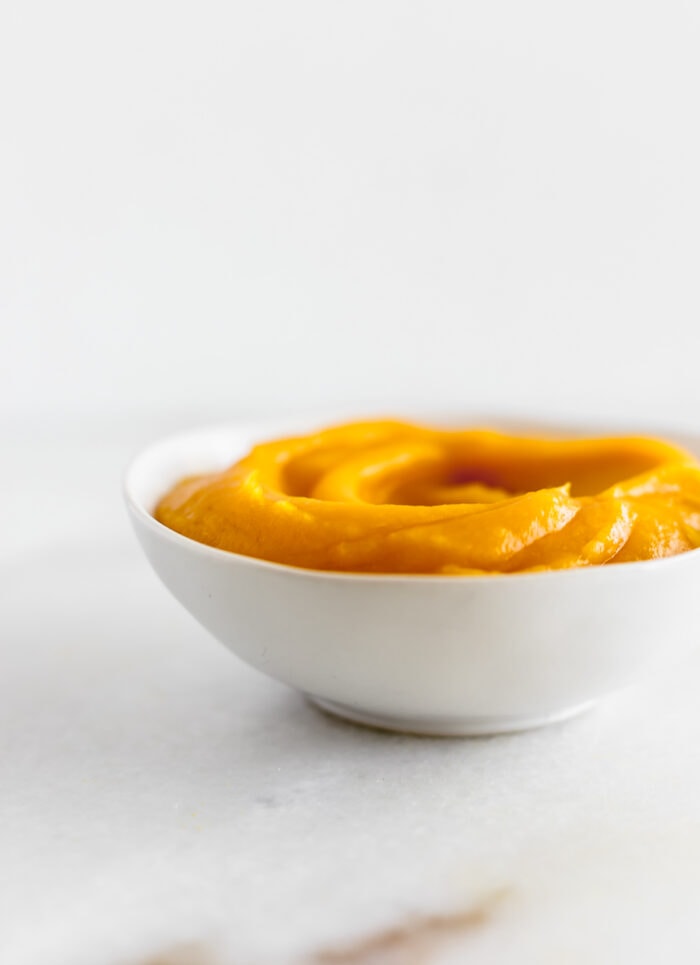 homemade pumpkin puree in a white bowl.