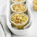 veggie quinoa egg muffins lined up in a white oval dish.