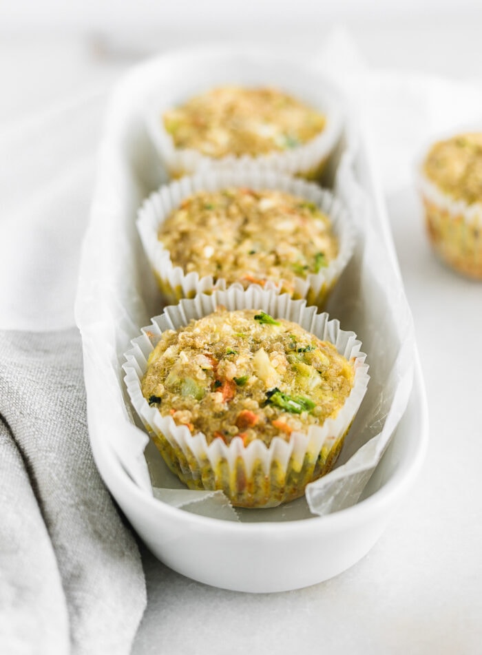 veggie quinoa egg muffins lined up in a white oval dish.