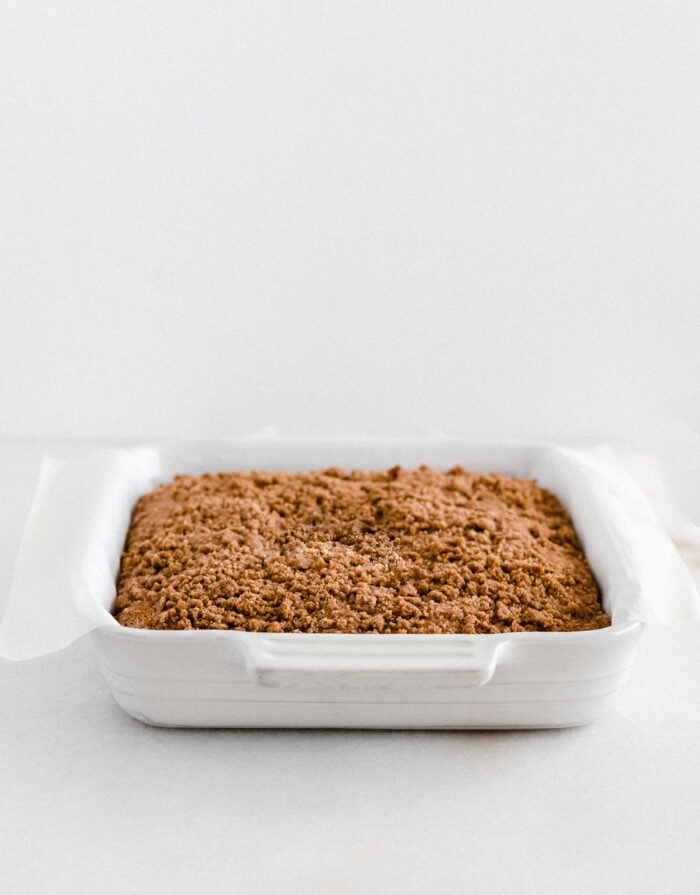 baked pumpkin coffee cake in a white baking dish.