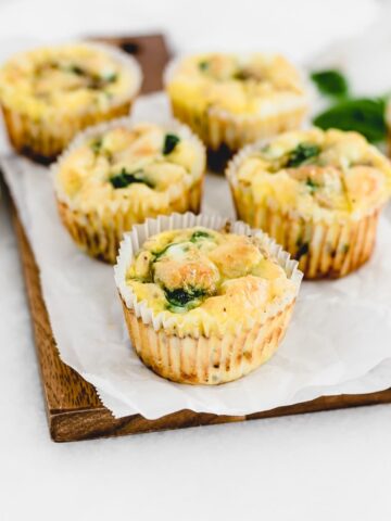mushroom spinach egg muffins on a wooden serving board.