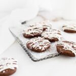 peppermint bark icebox cookies on a wire cooling rack with a white napkin in the background.