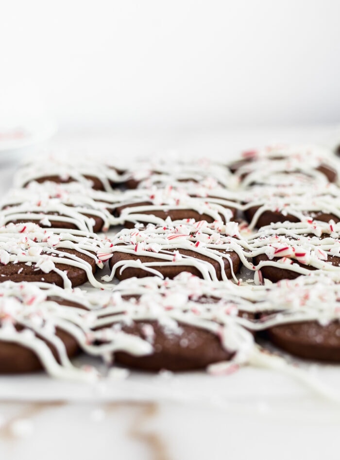 chocolate cookies drizzled iwth white chocolate and sprinkled with peppermint.