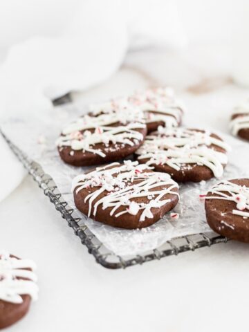 peppermint bark icebox cookies on a wire cooling rack with a white napkin in the background.