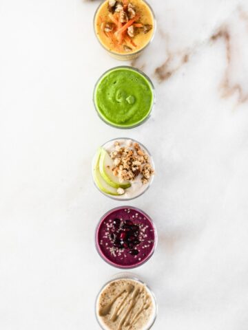 overhead view of 5 smoothies in a straight vertical line.