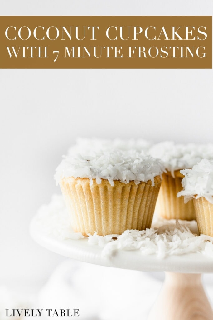 closeup of a coconut cupcake on a white cake stand with other coconut cupcakes with text overlay.