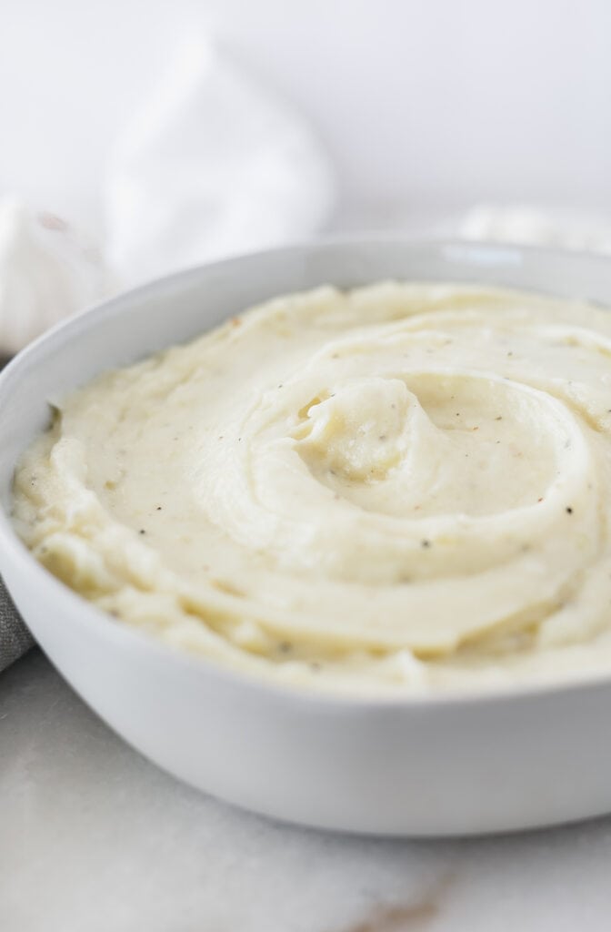 closeup of a bowl of whipped goat cheese mashed potatoes.