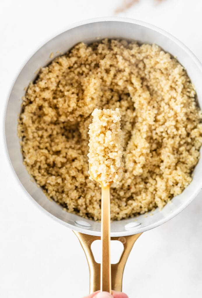 overhead view of a fork with fluffed quinoa on it.