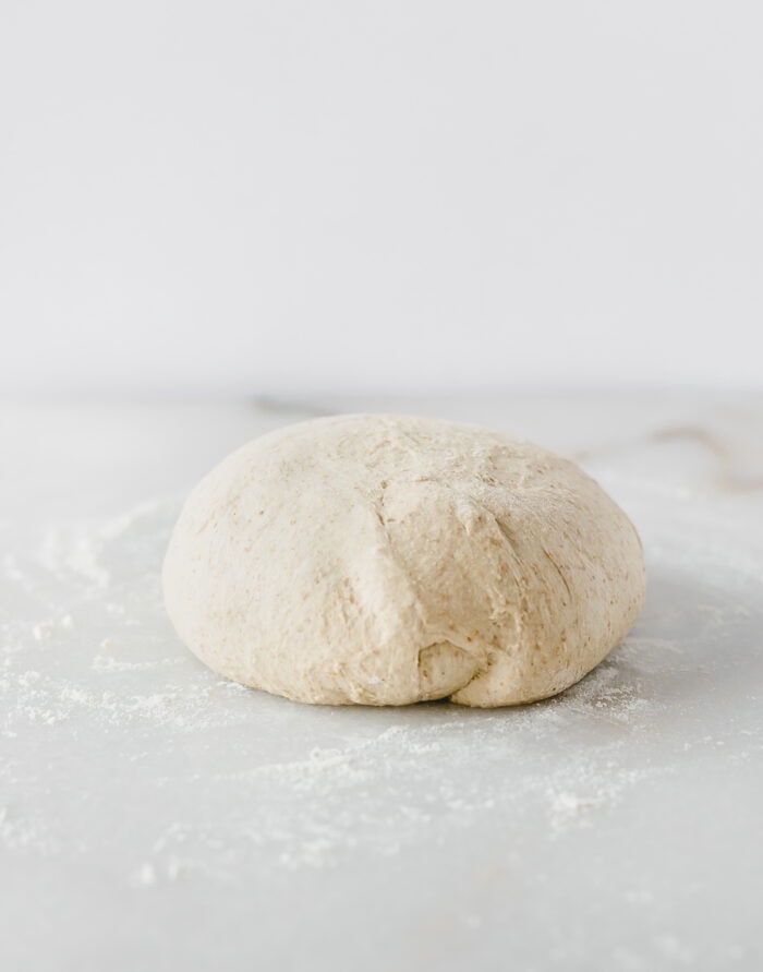 ball of sourdough pizza dough after bulk fermenation.
