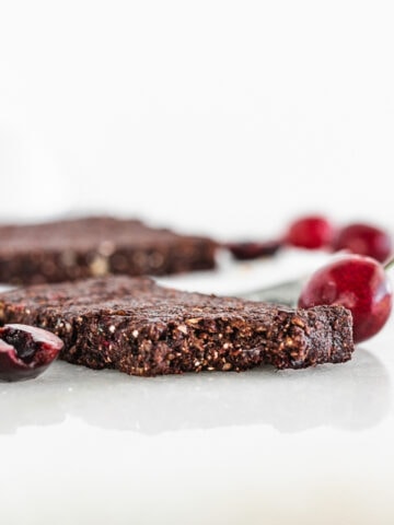 No bake cherry chocolate snack bar with a bite taken out.