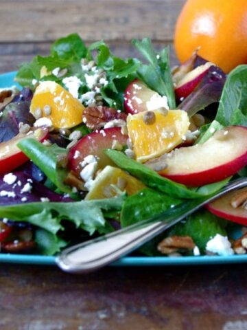 This fall salad pairs a plum-apricot hybrid with orange, lentils, goat cheese, pecans, and a simple red wine vinegar dressing.